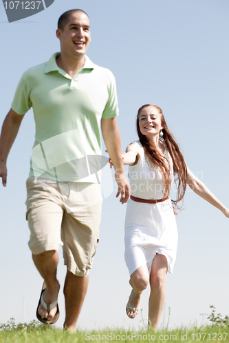 Image of young Couples Running At Park