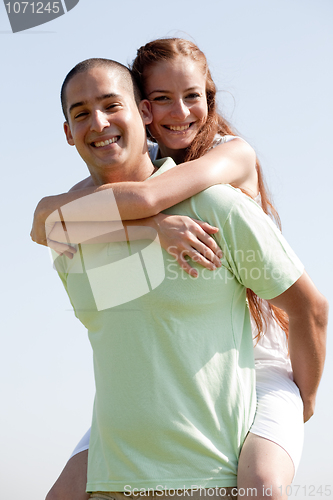 Image of Young Man Piggybacking His Girlfriend