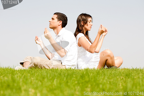 Image of young couple doing meditating