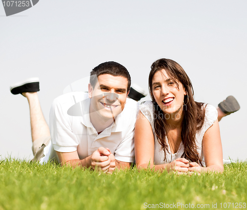 Image of happy Couple lie down on grass