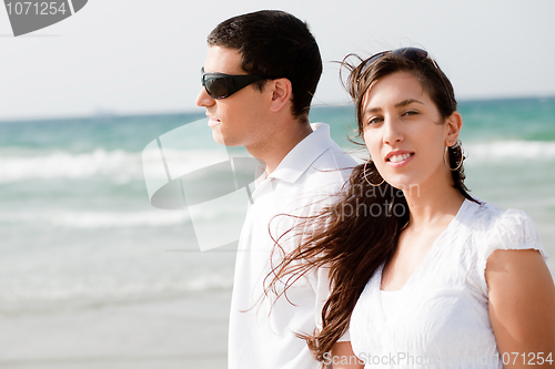 Image of young Cute Couple walk on the beach