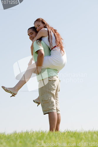 Image of Young Man Piggybacking His Girlfriend
