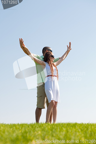 Image of young Couple Stretching Their Hands Together