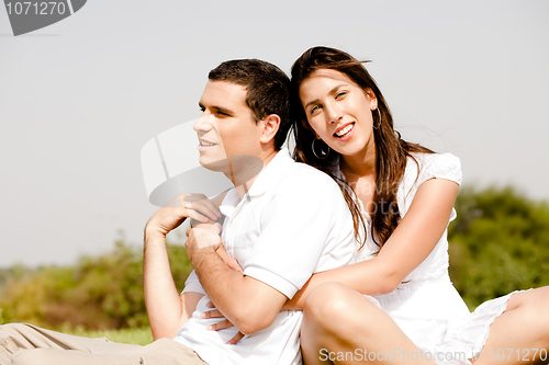 Image of love Couple Sitting Together Outside