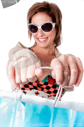 Image of Happy young woman with shopping bags on white