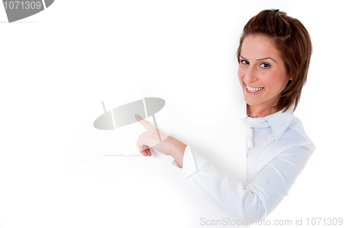 Image of young woman laughing by a blank board