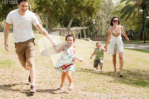 Image of Family running with two young children