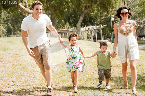 Image of Family running with two young children