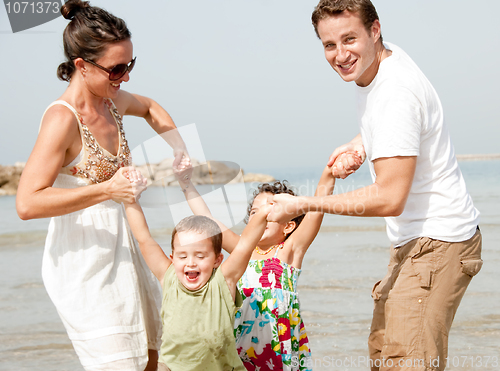 Image of Family playing on the beach