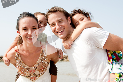 Image of Couple With Children On Backs