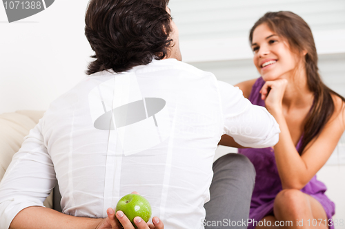 Image of man hiding fruit from his girlfriend