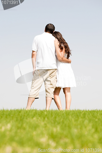 Image of Rear view of romantic young couple standing