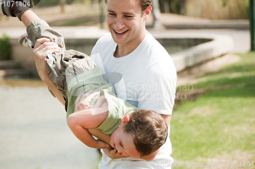 Image of father playing with son