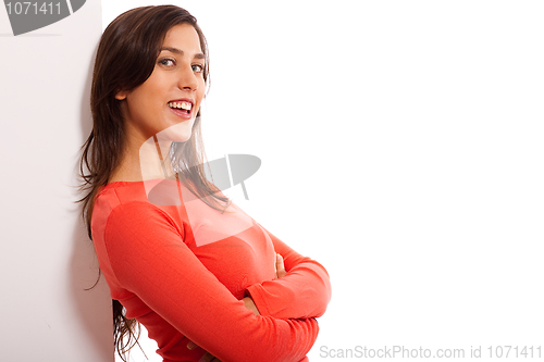 Image of Beautiful young woman standing by the blank baord