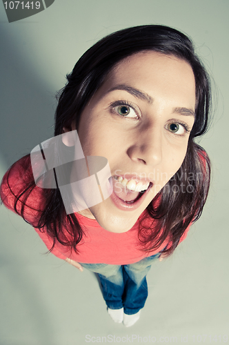 Image of close-up of a cheerful young woman looking up top view