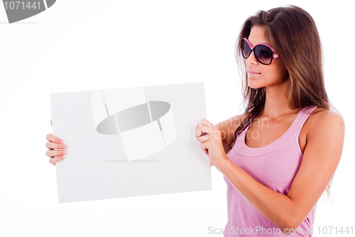 Image of closeup of beautiful young women showing blank board stright half lenth