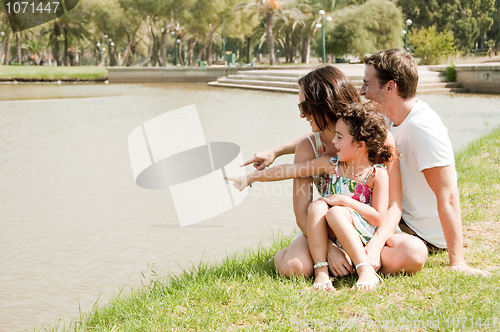 Image of Family sitting near the lake