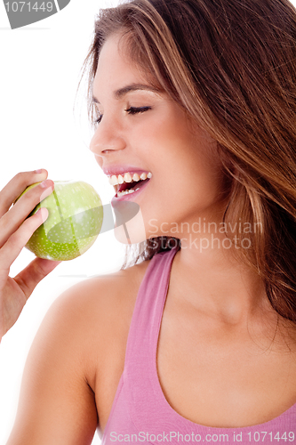 Image of happy young girl ready to bite a green apple