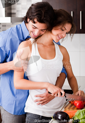 Image of Romantic couple enjoying their love in kitchen