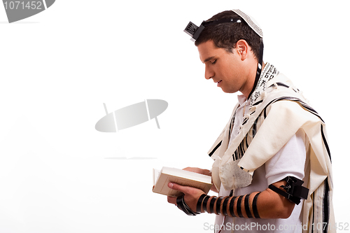 Image of Side view of young  jewish man with book