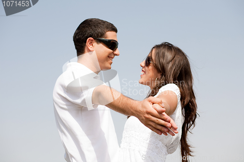 Image of Couple holding hands and looking eachother