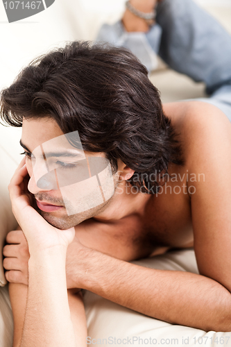 Image of man thinking by laying in sofa