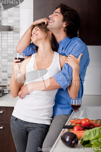 Image of Husband embrassing his wife from behind