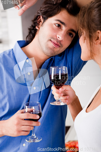 Image of man looking his wife with wine