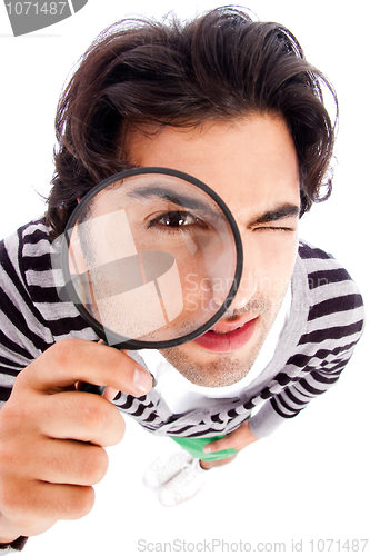 Image of young man looking up with a magnifying glass