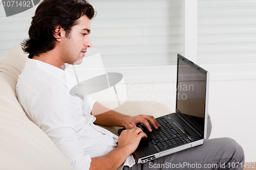 Image of young guy doing work at home