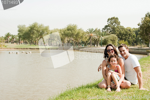 Image of Family sitting near the lake