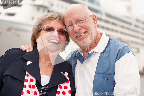 Image of Senior Couple On Shore in Front of Cruise Ship