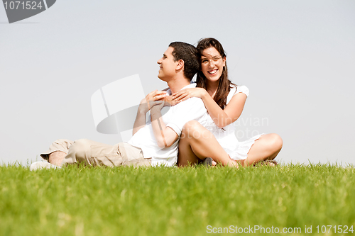 Image of Happy young women with arms around her husband