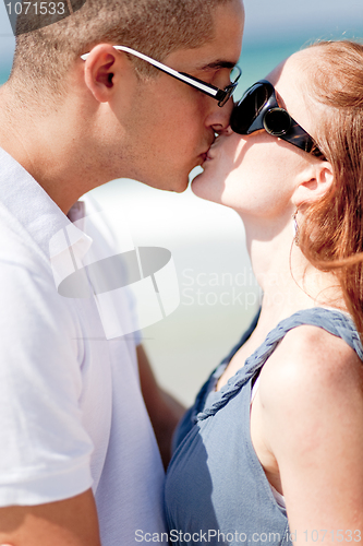 Image of Romantic Couple kissing on the beach