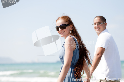 Image of Couple walking on the beach