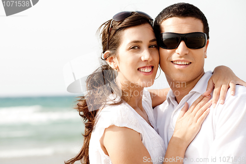 Image of Romantic coupleholding smiling eachother at the beach