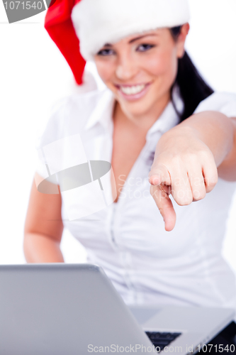 Image of Young santa woman pointing at the camera