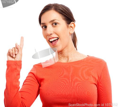 Image of Portrait of a happy young woman pointing up