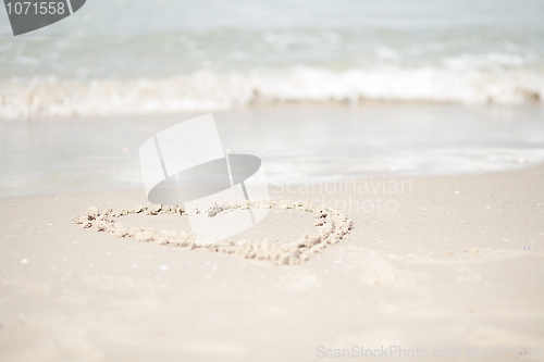 Image of Lovely Couple walking at the beach and look back