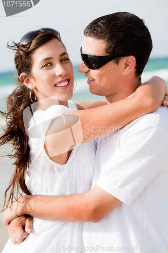 Image of Portrait of Romantic couple hugging passionately at the beach