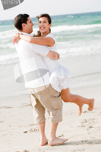 Image of Happy young couple having fun at the beach