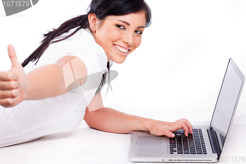 Image of young business Woman showing thumbs up sign