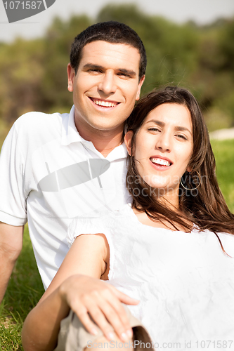 Image of Portrait of Happy young couple sitting and smiling