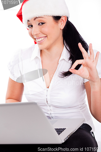 Image of Happy young santa girl showing perfect gesture