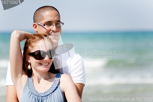 Image of Young couple holding passionately at the beach