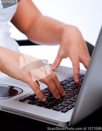 Image of Hands typing on laptop