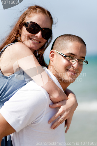 Image of Smiling young couple piggybacking