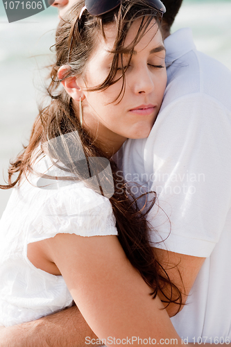 Image of young pretty woman relaxing on her husband shoulders