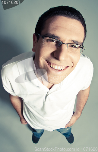 Image of Isolated close-up of a cheerful young man looking up