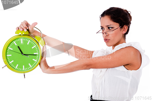 Image of Shot of a Young business woman holding clock